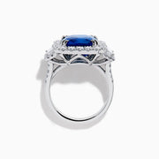 The Royale Bleu 18K White Gold Blue Sapphire and Diamond Halo Ring showcases a cushion-cut blue sapphire center with a double diamond halo and diamond side accents, elegantly set against a white background.