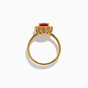 The 14K Yellow Gold Ruby and Diamond Halo Ring showcases an oval ruby center gemstone surrounded by a halo of round white diamonds, set in yellow gold and displayed against a white background.