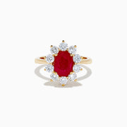 The 14K Yellow Gold Natural Ruby and Diamond Lady Di Ring showcases an oval natural ruby center with a halo of round white diamonds, set against a white background.