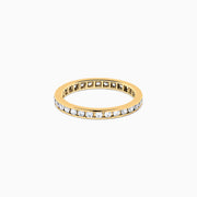 The 14K Yellow Gold Channel Set Diamond Eternity Band, 0.50 TCW, features small round white diamonds encircling the band and is shown on a white background.
