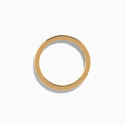 The 14K Yellow Gold Channel Set Diamond Eternity Band, 1.00 TCW, showcases a continuous row of round white diamonds in a channel setting, displayed on a white background.