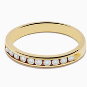 The 14K Yellow Gold 10-Stone Channel Set Diamond Band, 0.25 TCW, features a row of channel-set round diamonds along the band and is displayed on a white background.