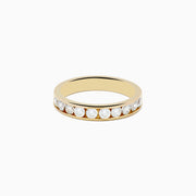 The 14K Yellow Gold 10-Stone Channel Set Diamond Band (0.75 TCW) features a row of round white diamonds in a channel setting, showcased against a plain white background.
