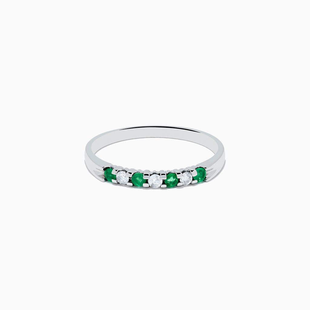 The 14K White Gold 7-Stone Emerald & Diamond Band, 0.25 TCW, showcases alternating round emeralds and diamonds set in a row along the band, displayed on a plain white background.