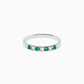 The 14K White Gold 7-Stone Emerald & Diamond Band, 0.25 TCW, showcases alternating round emeralds and diamonds set in a row along the band, displayed on a plain white background.