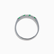 The 14K White Gold 7-Stone Emerald & Diamond Band, 0.25 TCW, showcases alternating round emeralds and diamonds set in a row along the band, displayed on a plain white background.