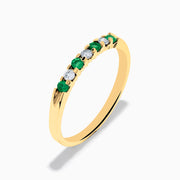 The 14K Yellow Gold 7-Stone Emerald & Diamond Band, 0.25 TCW, features alternating round white diamonds and emeralds set in a row on the band, shown against a white background.