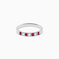 The 14K White Gold 7-Stone Ruby & Diamond Band, 0.25 TCW, showcases alternating vivid red rubies and sparkling round white diamonds set in a row along the band, shown on a white background.