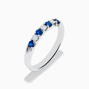 The 14K White Gold 7-Stone Blue Sapphire & Diamond Band (0.50 TCW) features alternating blue sapphires and diamonds set in a row, shown on a white background.