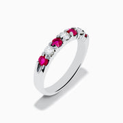 The 14K White Gold 7-Stone Ruby & Diamond Band, 0.65 TCW, features alternating round rubies and sparkling diamonds, showcased on a white background.