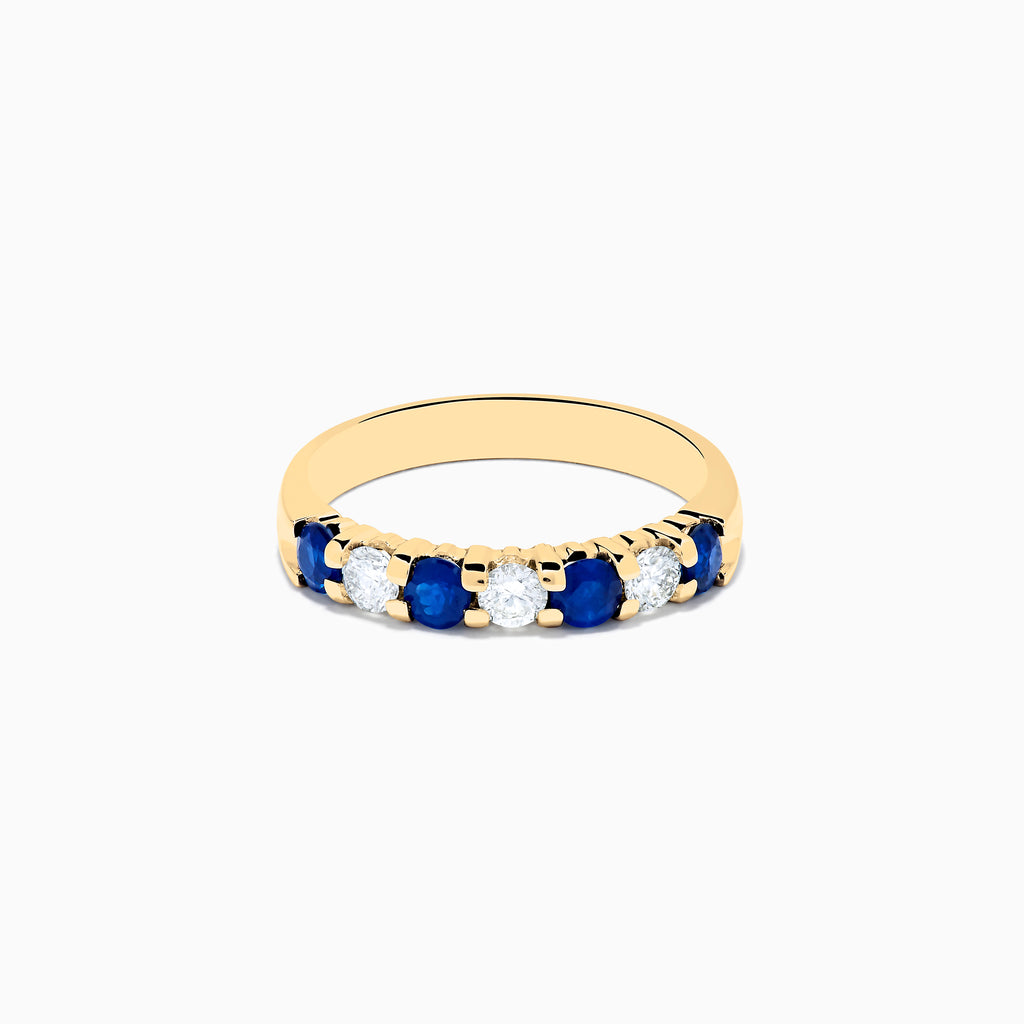 The 14K Yellow Gold 7-Stone Blue Sapphire & Diamond Band, 0.65 TCW, features alternating round blue sapphires and white diamonds set in a row along the band.