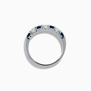 The 14K White Gold 7-Stone Blue Sapphire & Diamond Band, 1.00 TCW, features alternating round blue sapphires and white diamonds, displayed on a plain white background.