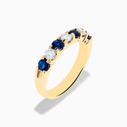 The 14K Yellow Gold 7-Stone Blue Sapphire & Diamond Band (1.00 TCW) features alternating blue sapphires and clear diamonds in a row along the gold band, shown on a white background.