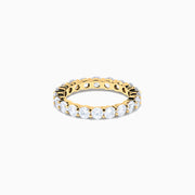 The 14K Yellow Gold Prong Set Diamond Eternity Band, 3.00 TCW, features round white diamonds encircling the entire ring and is shown against a plain white background.