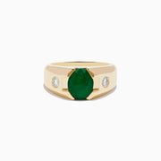 Mens 14K yellow gold emerald and diamond ring with a large oval emerald centerpiece and two small round diamonds set on each side, shown against a white background.