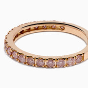 The 18K Rose Gold Pink Diamond Pavé Band Ring showcases a row of sparkling pink diamonds set along the band, photographed on a plain white background.