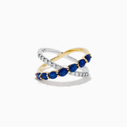 The Royale Bleu 14K Two Tone Gold Sapphire and Diamond Criss Cross Ring features alternating sapphires and clear diamonds, elegantly displayed against a white background.
