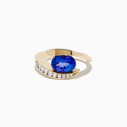 The Nahla Siri 14K Yellow Gold Tanzanite and Diamond Ring by Effy features a large oval tanzanite center stone, accented with a curved row of small round diamonds set along one side of the gold band.