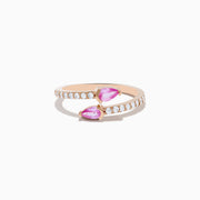 The 14K Rose Gold Pink Sapphire and Diamond Bypass Ring features two pear-shaped pink sapphires at each end and round white diamonds along the band, shown on a white background.