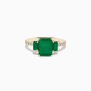 The Brasilica 14K Yellow Gold Emerald and Diamond Ring showcases a large rectangular emerald center, two smaller side emeralds, and diamond accents on the band.