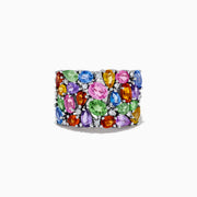The Watercolors 14K White Gold Multi Sapphire and Diamond Ring features a wide band adorned with vibrant, closely set sapphires in various colors, shapes, and sizes alongside sparkling diamonds for a colorful, eye-catching design.