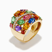 Introducing the 14K Yellow Gold Multi Sapphire and Diamond Statement Ring: This bold ring showcases a wide band of 14K yellow gold, highlighted by luminous oval sapphires in green, orange, pink, blue, and purple. A diagonal row of sparkling white diamonds crosses the center, creating a dazzling focal point that makes this sapphire ring an eye-catching and colorful addition to any jewelry collection.