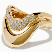 The 14K Yellow Gold Diamond Sculptural Ribbon Ring features a wavy V-shaped design with a sparkling diamond ribbon band above a polished gold band, creating an elegant two-layer look.