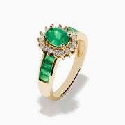 The Brasilica 14K Yellow Gold Emerald and Diamond Ring features an oval emerald center, sparkling diamonds, and elegant green inlays along the band.