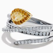 The 18K Two-Tone Gold White and Yellow Diamond Crossover Bypass Ring showcases overlapping diamond bands, a large pear-shaped yellow diamond at the center, and smaller yellow diamonds for a striking two-tone effect.