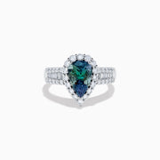 The 18K White Gold GIA Certified Pear Zoisite and Diamond Ring showcases a striking blue-green gemstone accented by round diamonds, with more diamonds along the band for extra brilliance and certified authenticity.