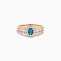 The 18K Rose Gold IGI Certified Alexandrite and Diamond Ring features an oval alexandrite center, a halo of white diamonds, and diamond-accented rows along the band.