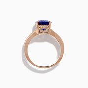 The Nahla 14K Rose Gold Tanzanite and Diamond Ring showcases an oval-cut blue tanzanite centerpiece accented by round diamonds on the band, set against a white background.