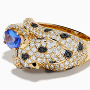 The Signature 14K Yellow Gold Tanzanite and Diamond Panther Ring showcases a sculpted panther with green gemstone eyes, diamond and black stone accents, holding an oval tanzanite gemstone.