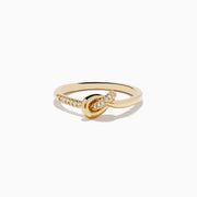 The Doro 14K Yellow Gold Diamond Knot Ring features a central knot design with one side of the band accented by sparkling diamonds, shown on a white background.