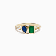 The 14K Yellow Gold Emerald and Sapphire Toi Et Moi Diamond Ring features a teardrop sapphire, rectangular green emerald, and small diamonds set along half the band, shown on a white background.