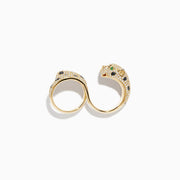The Signature 14K Gold Emerald, Black and White Double Finger Ring features a panther design wrapping around two fingers, with emerald-green eyes, black spots, and small white gemstones encrusted on its body and tail.