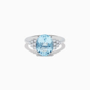 The Aquarius 14K White Gold Aquamarine and Diamond Ring showcases a large oval aquamarine center stone, accented by three rows of round diamonds on each side against a white gold setting.