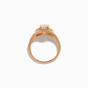 The Rose Gold Morganite and Diamond Split Halo Ring showcases an oval peach-colored Morganite center, encircled by a sparkling diamond split halo with additional diamonds along the band.