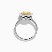 The 18K Two Toned Gold GIA certified Yellow and White Diamond Halo Ring features a rectangular yellow center stone, double halos of white diamonds, and extra diamonds along the band for exceptional brilliance.
