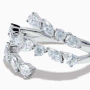 The Lab Grown Multi Shaped Diamond 1.23ct Wrap Ring in 14K White Gold features pear and round lab grown diamonds in a leaf-inspired, open front design, shown against a white background.