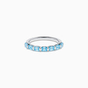 The Lab Grown Blue Diamond Emerald Cut Stacking Band in 14K White Gold features a row of emerald cut lab-grown blue diamonds set along the band, displayed on a plain white background.