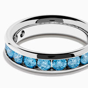 The Lab Grown Blue Diamond Channel Set Band in 14K White Gold features a row of round blue diamonds encircling the band, shown elegantly on a plain white background.