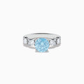 The 14K White Gold Lab Grown Blue and White Diamond Ring features a large round blue gemstone in the center, flanked by three smaller lab grown diamonds on each side, set against a plain white background.