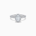 The Lab Grown Oval Diamond Halo and Hidden Halo Ring in 14K White Gold showcases an oval lab grown diamond center, a sparkling diamond halo, hidden halo accents, and additional diamonds along the band.