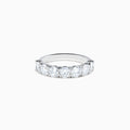 The Lab Grown Diamond Wedding Band in 14K White Gold showcases round, sparkling lab diamonds in a shared-prong setting on a sleek band, set against a white background.