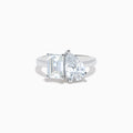 The Lab Grown Diamond Toi Et Moi Ring in 14K White Gold showcases emerald-cut and pear-shaped lab diamonds set side by side on a sleek band, displayed against a white background.