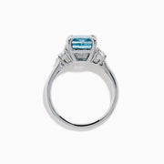 Lab Grown Blue and White Diamond 3-Stone Ring in 14K White Gold, featuring a prominent cushion-cut blue and white diamond center with two clear triangular side stones, shown on a white background.