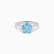 The Lab Grown Blue and White Diamond 3 Stone Ring in 14K White Gold features a striking round blue gemstone center with two rectangular lab grown diamonds on each side, all set in elegant white gold.