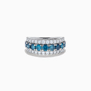 The Lab Grown Blue and White Diamond Wide Band Ring in 14K White Gold showcases a central row of blue stones flanked by lab grown diamonds in a striking triple-band design.