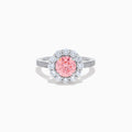 The Lab Grown Pink and White Diamond Halo Ring in 14K White Gold features a round pink gemstone center, surrounded by a halo of lab grown diamonds and additional diamonds along the elegant band.